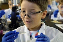 Student at Gene-ius Day with test tube